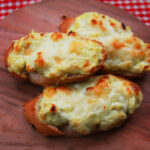 Three Toasted Artichoke Bruschetta on a Wooden Cutting Board